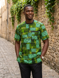 Man wearing Ankara geometric patchwork short sleeve top in forest green and mint