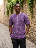 Man wearing royal purple Bogolan geometric print Senator short sleeve top with black trousers